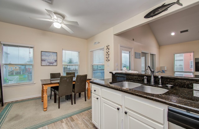 16713 Kingston Way, Jamaica Beach, TX 77554 - kitchen with dishwasher, light wood-style flooring, dark stone counters, white cabinetry, and ceiling fan