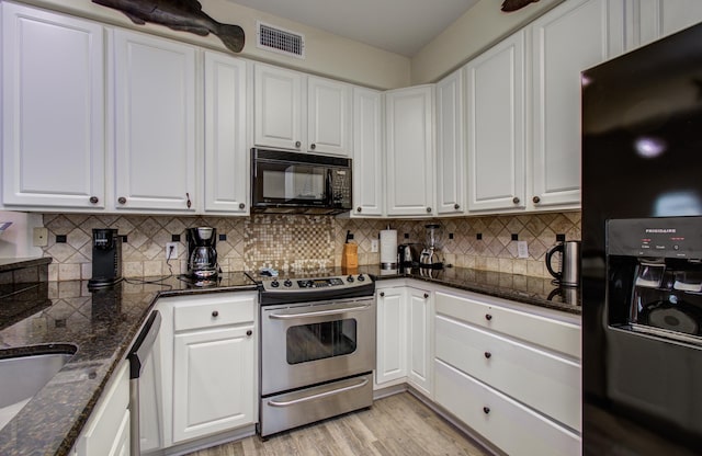 16713 Kingston Way, Jamaica Beach, TX 77554 - kitchen featuring black appliances, white cabinetry, light wood-style floors, and tasteful backsplash