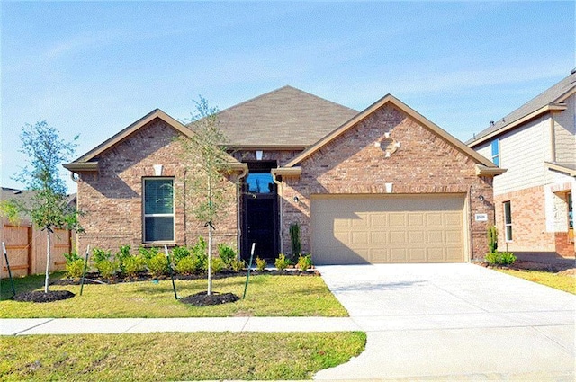 15619 Hanover Breeze Ln, Houston, TX 77044 - view of front of house featuring a garage, concrete driveway, and brick siding