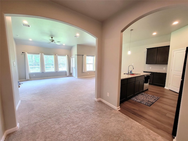 2320 Cedar Place Dr, Conroe, TX 77306 - hall with arched walkways, recessed lighting, light carpet, and light wood-type flooring