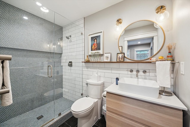 6210 Darnell St, Houston, TX 77074 - full bath with tile walls, a shower stall, vanity, recessed lighting, and tile patterned flooring