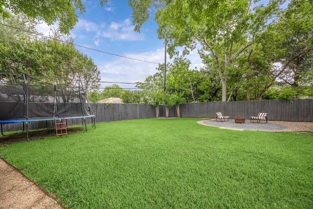 6210 Darnell St, Houston, TX 77074 - fenced backyard featuring a trampoline and a fire pit