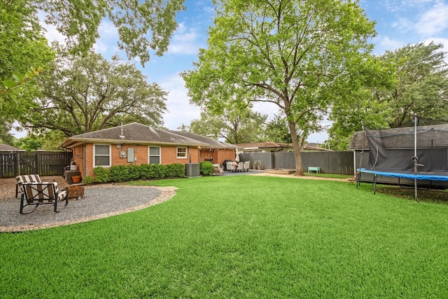 6210 Darnell St, Houston, TX 77074 - fenced backyard featuring a trampoline, an outdoor fire pit, and a patio
