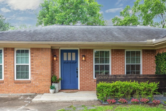 6210 Darnell St, Houston, TX 77074 - view of front of home with a shingled roof and brick siding