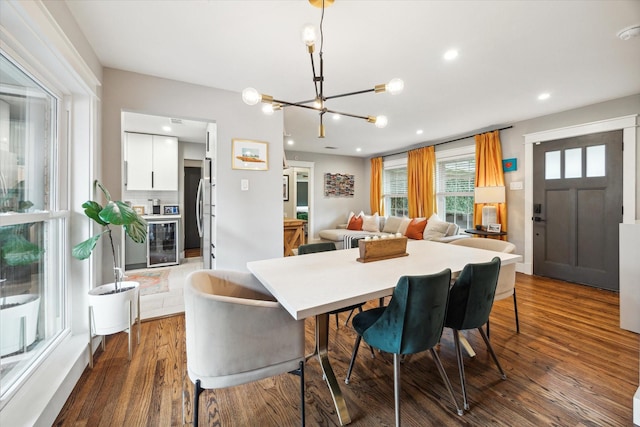 6210 Darnell St, Houston, TX 77074 - dining space with wine cooler, a chandelier, dark wood finished floors, and recessed lighting