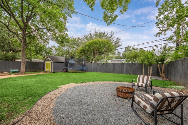 6210 Darnell St, Houston, TX 77074 - fenced backyard with a fire pit, a storage shed, a trampoline, and a patio