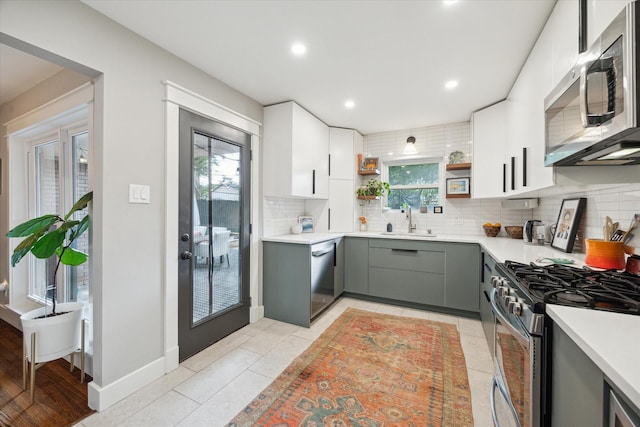 6210 Darnell St, Houston, TX 77074 - kitchen featuring stainless steel appliances, decorative backsplash, gray cabinets, light countertops, and recessed lighting