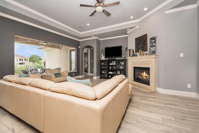 3038 S Island Dr, Seabrook, TX 77586 - living room featuring light wood finished floors, ceiling fan, recessed lighting, a glass covered fireplace, and arched walkways