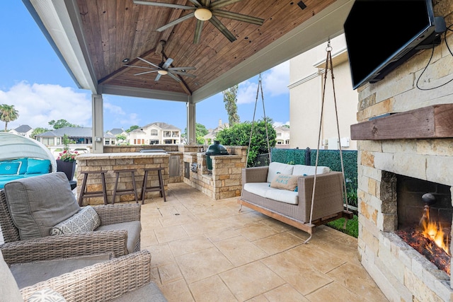 3038 S Island Dr, Seabrook, TX 77586 - view of patio / terrace with an outdoor kitchen, a ceiling fan, a residential view, and an outdoor living space with a fireplace