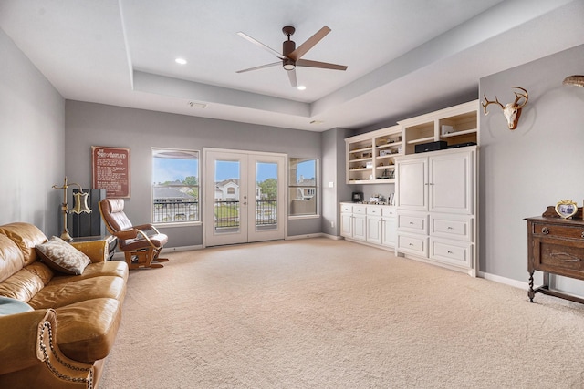 3038 S Island Dr, Seabrook, TX 77586 - living room featuring light colored carpet, a raised ceiling, ceiling fan, french doors, and recessed lighting