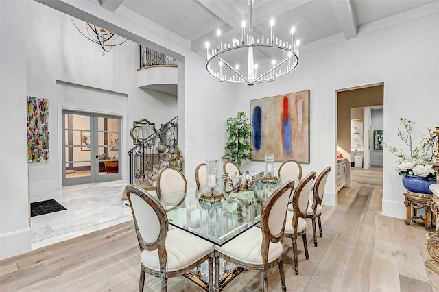 4622 Banning Dr, Houston, TX 77027 - dining room featuring beam ceiling, a chandelier, wood finished floors, stairs, and french doors