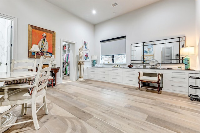 4622 Banning Dr, Houston, TX 77027 - misc room with a towering ceiling, light wood-style floors, and recessed lighting