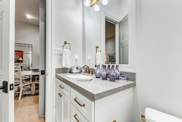 4622 Banning Dr, Houston, TX 77027 - bathroom featuring vanity, wood finished floors, and recessed lighting
