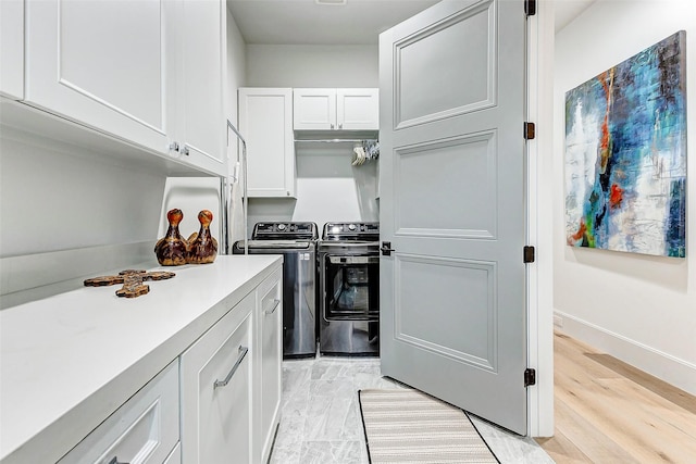 4622 Banning Dr, Houston, TX 77027 - kitchen featuring independent washer and dryer, white cabinets, and light countertops
