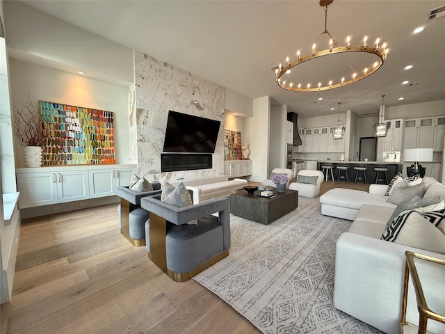 4622 Banning Dr, Houston, TX 77027 - living area featuring a chandelier, light wood-style flooring, and recessed lighting