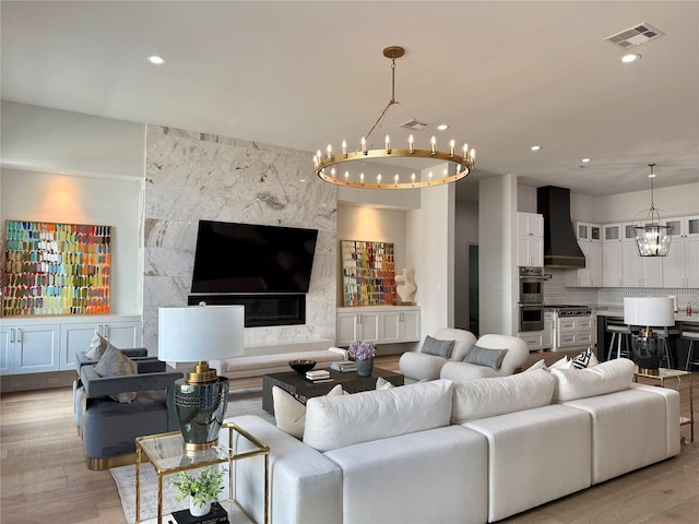 4622 Banning Dr, Houston, TX 77027 - living area featuring a chandelier, light wood finished floors, and recessed lighting