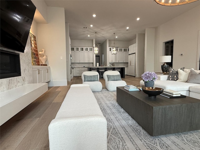 4622 Banning Dr, Houston, TX 77027 - living room featuring light wood-type flooring, recessed lighting, and a chandelier