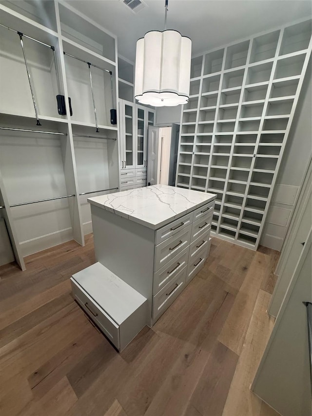 4622 Banning Dr, Houston, TX 77027 - walk in closet with wood finished floors