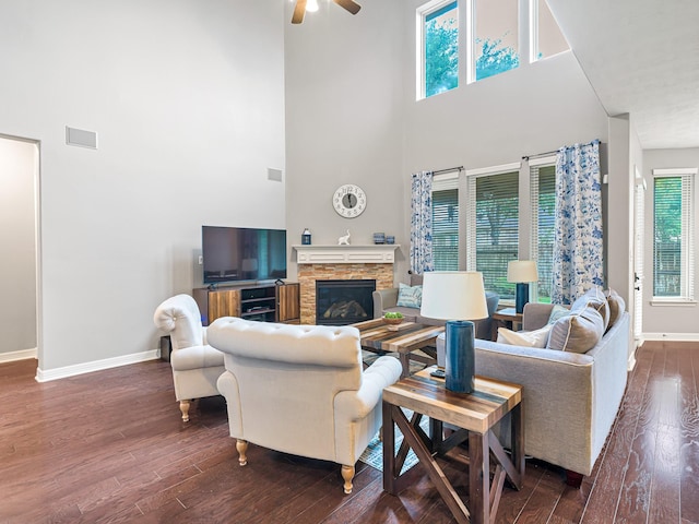 3314 Flint Valley Ln, Katy, TX 77494 - living room with a towering ceiling, dark wood-style floors, a ceiling fan, and a stone fireplace