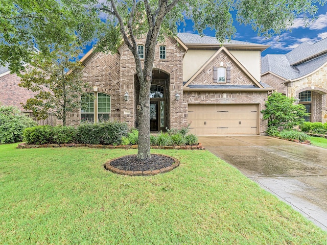 3314 Flint Valley Ln, Katy, TX 77494 - french country inspired facade featuring concrete driveway, a front yard, stucco siding, and brick siding
