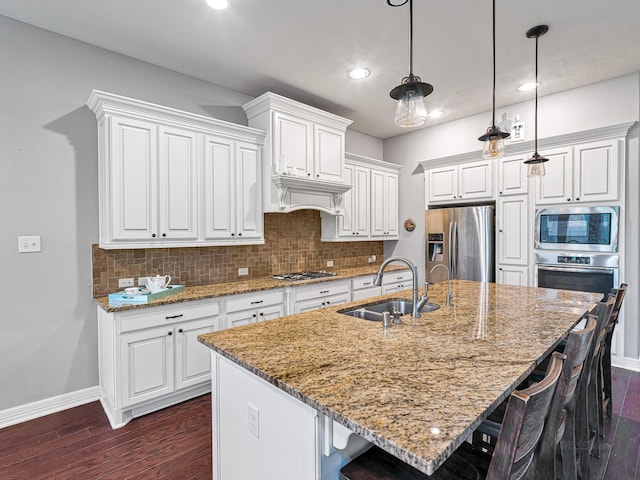 3314 Flint Valley Ln, Katy, TX 77494 - kitchen featuring appliances with stainless steel finishes, dark wood-style flooring, a kitchen bar, tasteful backsplash, and white cabinetry