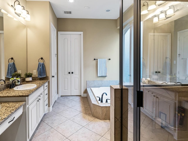 3314 Flint Valley Ln, Katy, TX 77494 - full bathroom with two vanities, a garden tub, a closet, and tile patterned flooring
