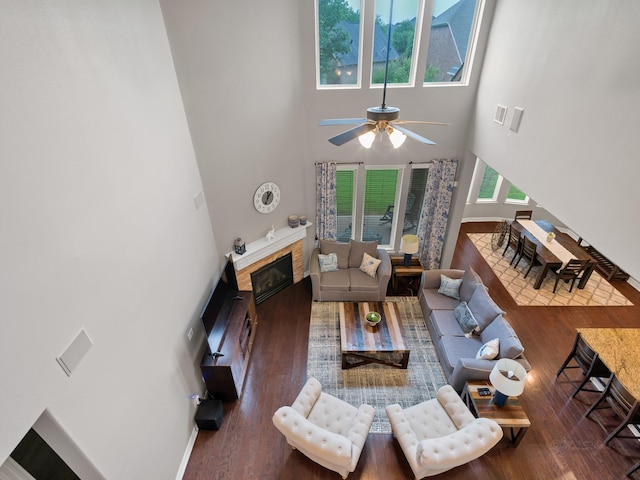 3314 Flint Valley Ln, Katy, TX 77494 - living area featuring a high ceiling, a ceiling fan, wood finished floors, and a glass covered fireplace