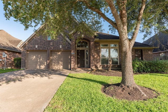 2407 Lost Bridge Ln, Pearland, TX 77584 - view of front facade with brick siding, driveway, a garage, and a front lawn