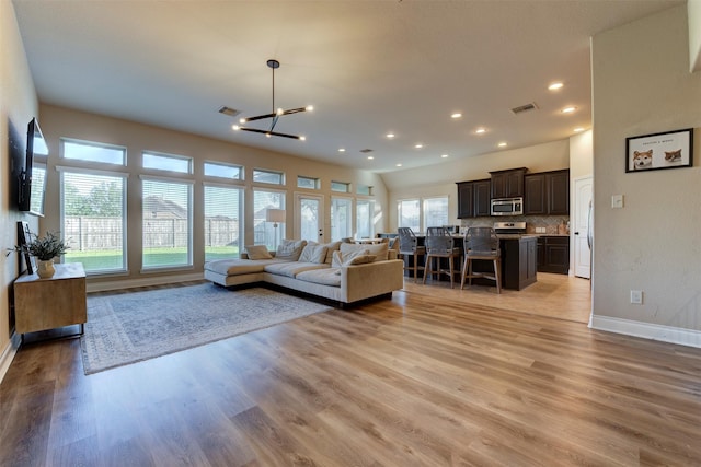 2407 Lost Bridge Ln, Pearland, TX 77584 - living room with light wood-style flooring, a chandelier, and recessed lighting