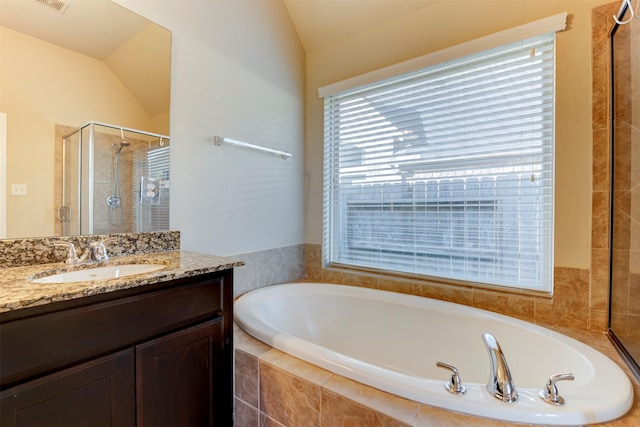 2407 Lost Bridge Ln, Pearland, TX 77584 - full bath featuring vaulted ceiling, a garden tub, vanity, healthy amount of natural light, and a shower stall