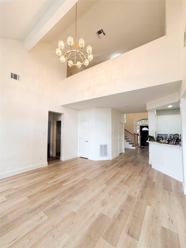 2415 Jasmine Ridge Ct, Houston, TX 77062 - unfurnished living room with a high ceiling, light wood-style flooring, a chandelier, stairs, and beamed ceiling