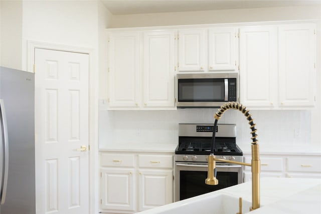 2415 Jasmine Ridge Ct, Houston, TX 77062 - kitchen with appliances with stainless steel finishes, white cabinets, and light countertops
