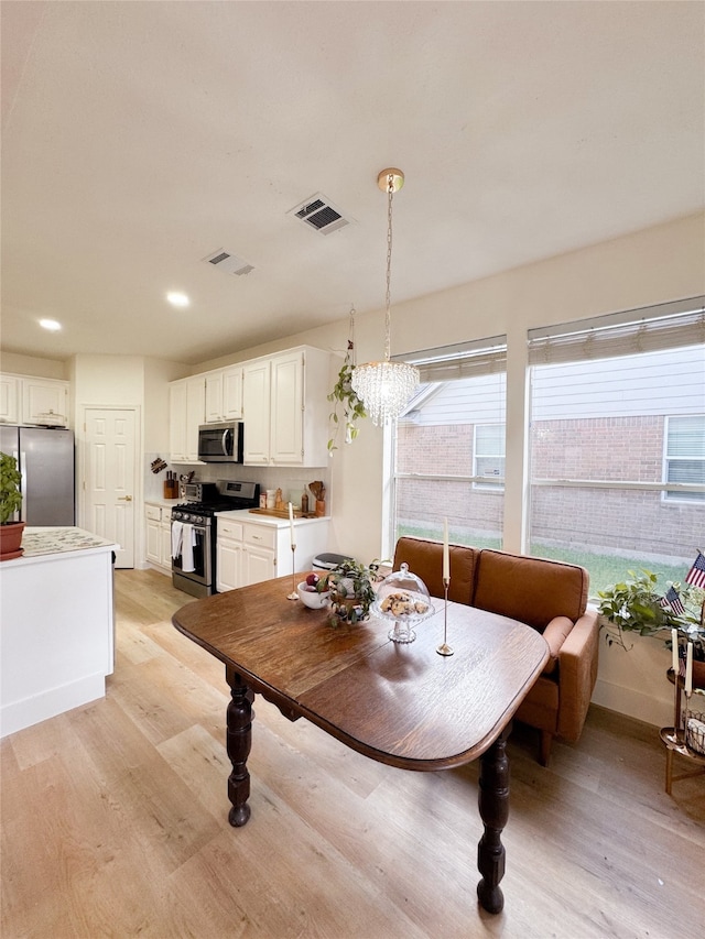 2415 Jasmine Ridge Ct, Houston, TX 77062 - dining space featuring light wood-style flooring, a chandelier, and recessed lighting