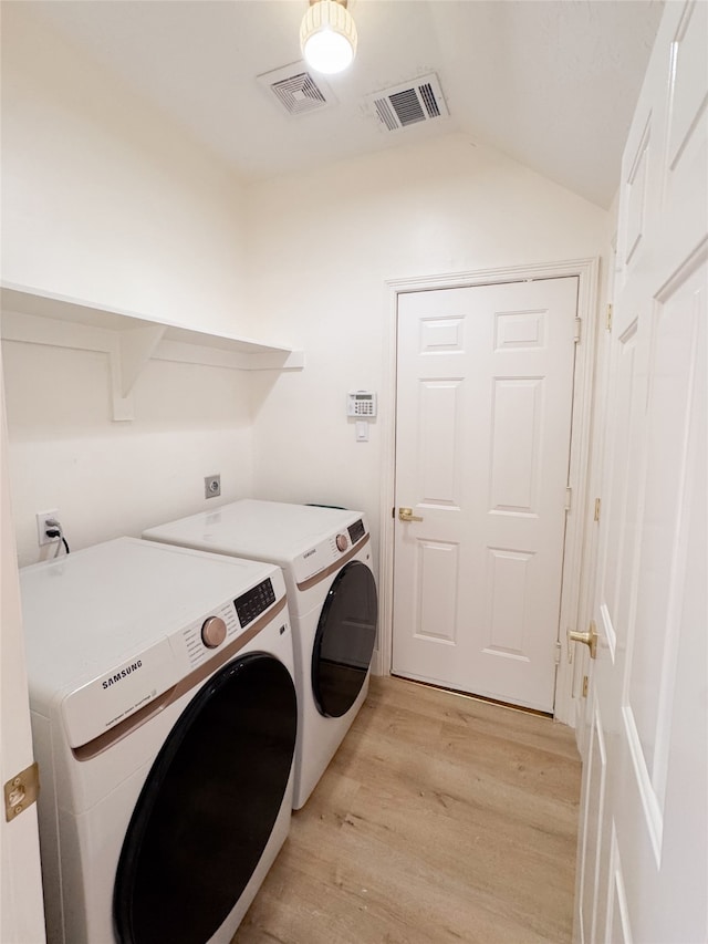 2415 Jasmine Ridge Ct, Houston, TX 77062 - laundry area featuring washer and dryer and light wood finished floors
