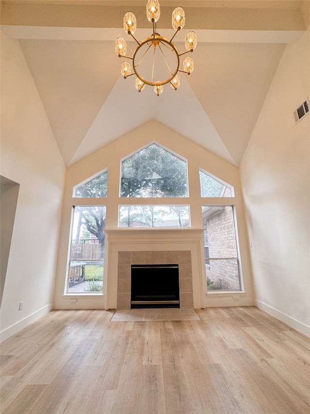 2415 Jasmine Ridge Ct, Houston, TX 77062 - unfurnished living room with a chandelier, wood finished floors, healthy amount of natural light, a fireplace, and high vaulted ceiling