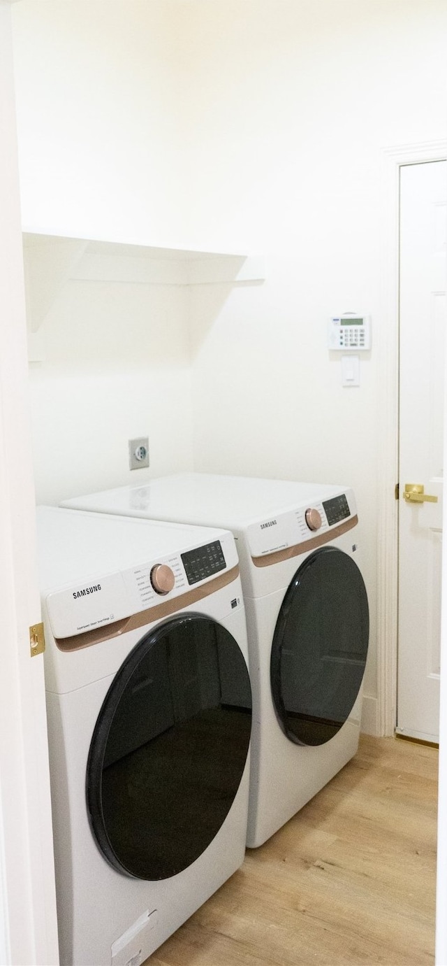 2415 Jasmine Ridge Ct, Houston, TX 77062 - washroom with separate washer and dryer and light wood-type flooring