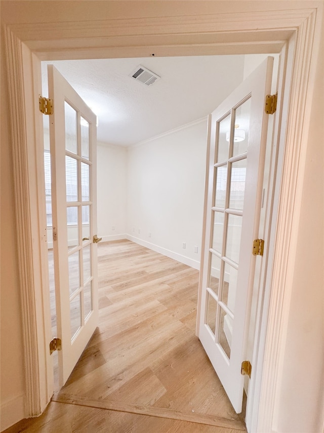 2415 Jasmine Ridge Ct, Houston, TX 77062 - hall with french doors, light wood-type flooring, and crown molding