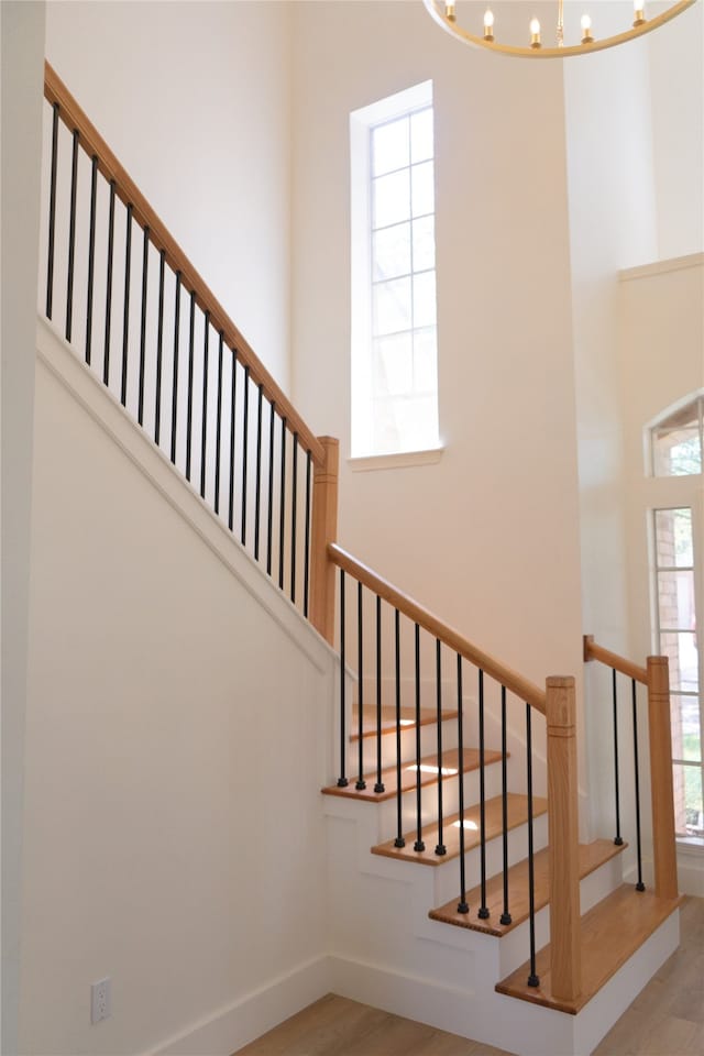 2415 Jasmine Ridge Ct, Houston, TX 77062 - stairs with wood finished floors, healthy amount of natural light, a chandelier, and a high ceiling