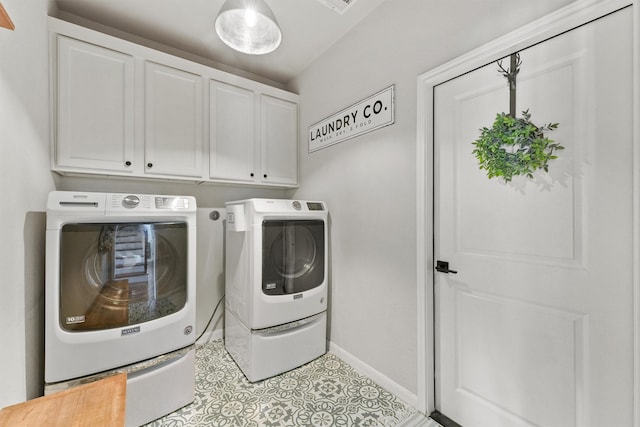 2307 Hagerman Rd, Conroe, TX 77384 - laundry area featuring separate washer and dryer, cabinet space, and light tile patterned floors