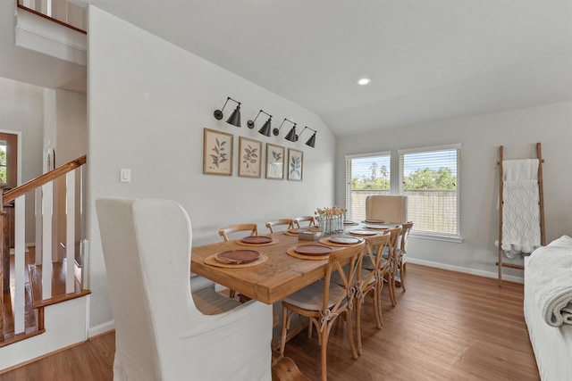 2307 Hagerman Rd, Conroe, TX 77384 - dining room featuring wood finished floors, recessed lighting, lofted ceiling, and stairs
