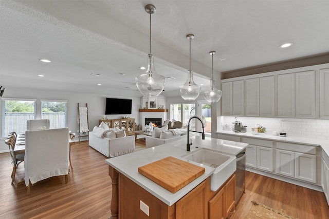 2307 Hagerman Rd, Conroe, TX 77384 - kitchen with light wood finished floors, plenty of natural light, recessed lighting, tasteful backsplash, and light countertops