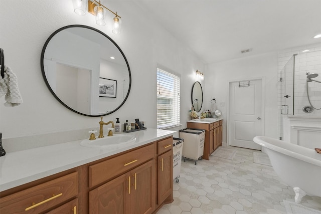 2307 Hagerman Rd, Conroe, TX 77384 - bathroom with two vanities, a shower stall, a freestanding bath, tile patterned floors, and recessed lighting