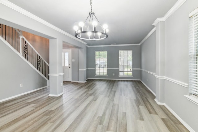 5911 Drenner Park Ln, Houston, TX 77086 - unfurnished dining area featuring a chandelier, wood finished floors, ornamental molding, and stairs