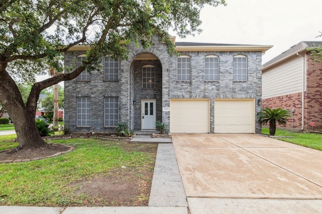5911 Drenner Park Ln, Houston, TX 77086 - view of front of house featuring a garage, driveway, a front yard, and brick siding