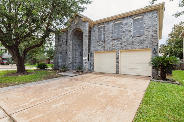 5911 Drenner Park Ln, Houston, TX 77086 - view of front facade with a garage, concrete driveway, a front yard, and brick siding