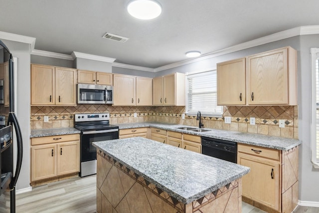 5911 Drenner Park Ln, Houston, TX 77086 - kitchen with black appliances, light brown cabinets, and crown molding