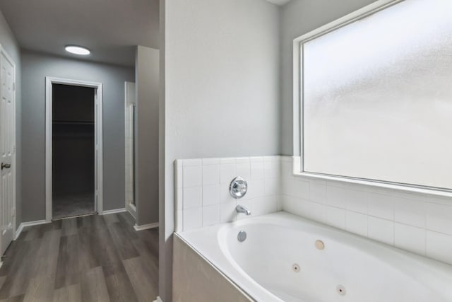 5911 Drenner Park Ln, Houston, TX 77086 - bathroom with wood finished floors, a jetted tub, and a shower stall