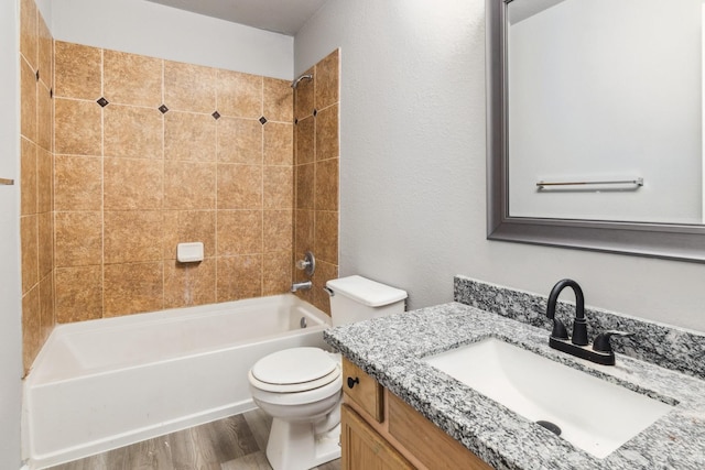 5911 Drenner Park Ln, Houston, TX 77086 - full bath featuring vanity, washtub / shower combination, and wood finished floors