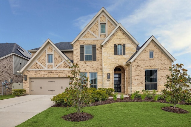 17471 Bayflower, Conroe, TX 77385 - view of front of home with brick siding, concrete driveway, a front lawn, and stone siding