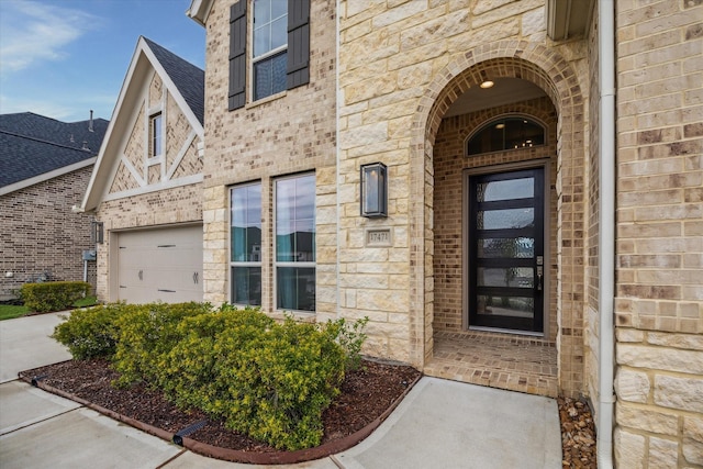 17471 Bayflower, Conroe, TX 77385 - property entrance featuring stone siding, brick siding, a garage, and a shingled roof
